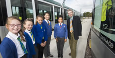 Councillor Alan Clark and girls from Whitemoor Academy naming a tram