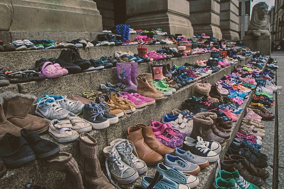 Shoes on Council House steps to illustrate the number of children in care.