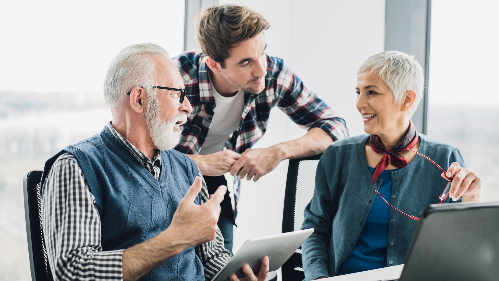 Picture of young man talking to older couple