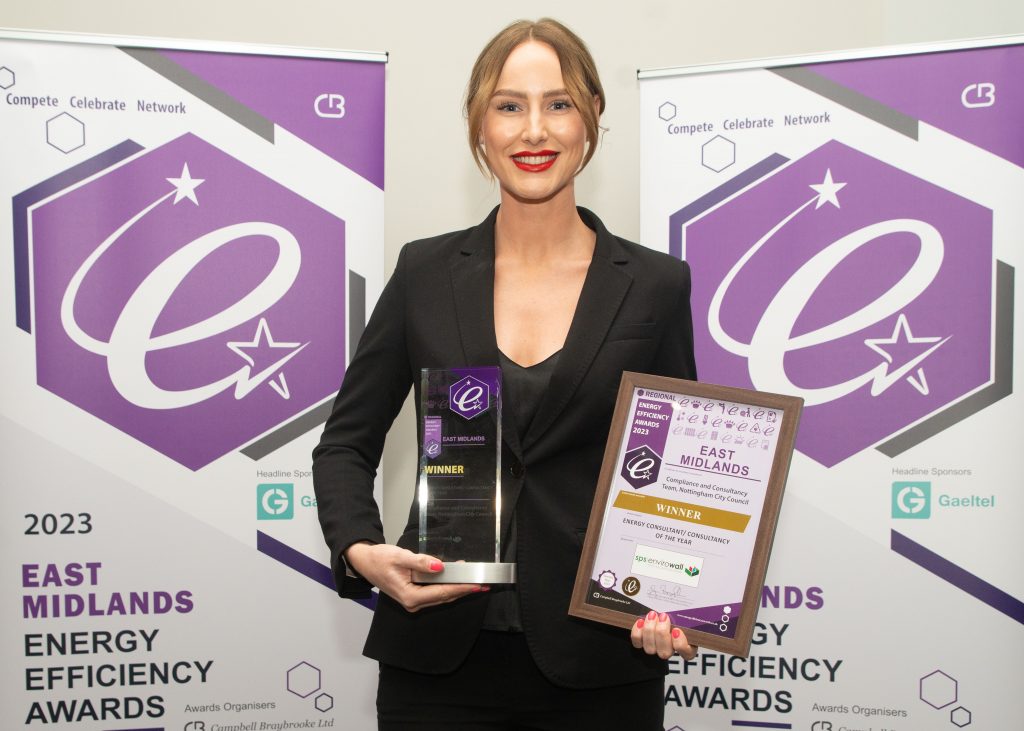 Gina Clarke at the Energy Efficiency Awards holding the trophy for Energy Consultant of the Year