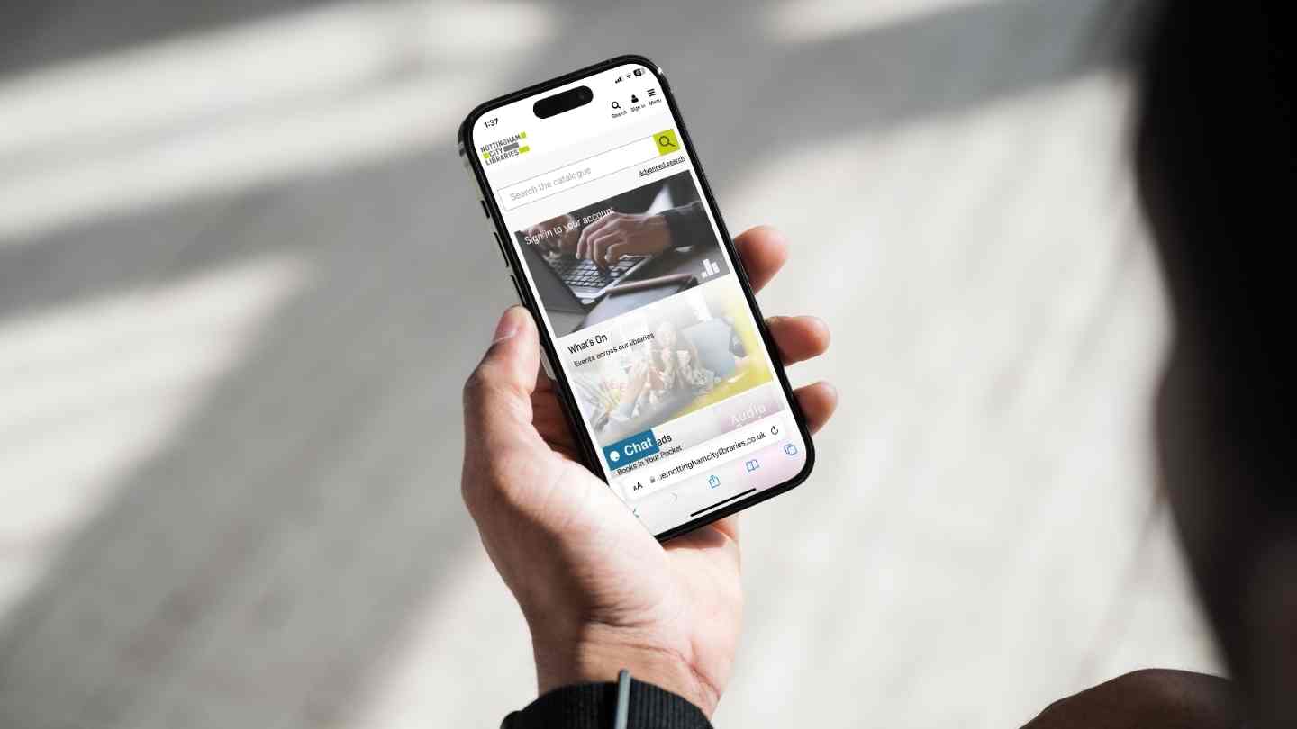 Person holding a smartphone and viewing the Nottingham City Libraries website