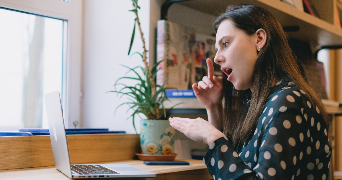 Woman on laptop communicating in British Sign Language