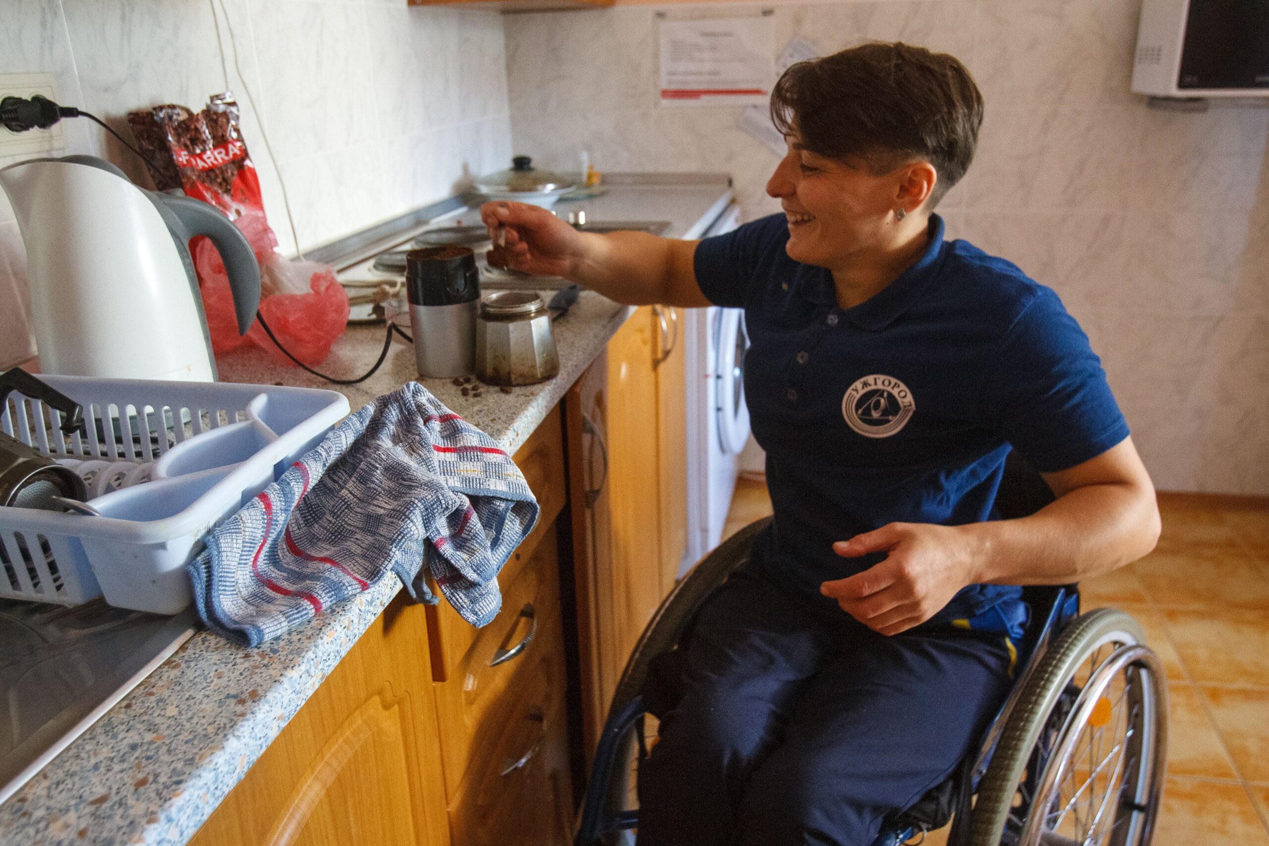 A person in a wheelchair preparing food at home